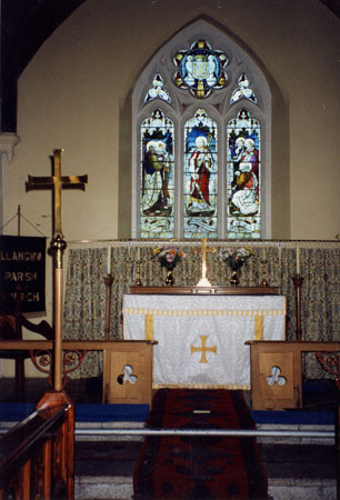 Coloured photograph of the altar and memorial window in St Jerome's Church Llangwm Pembrokeshire